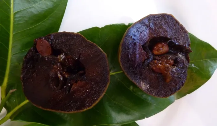 Black sapote cut in half